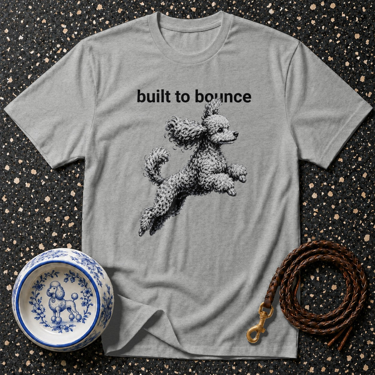 Grey t-shirt with "built to bounce" text and a poodle jumping