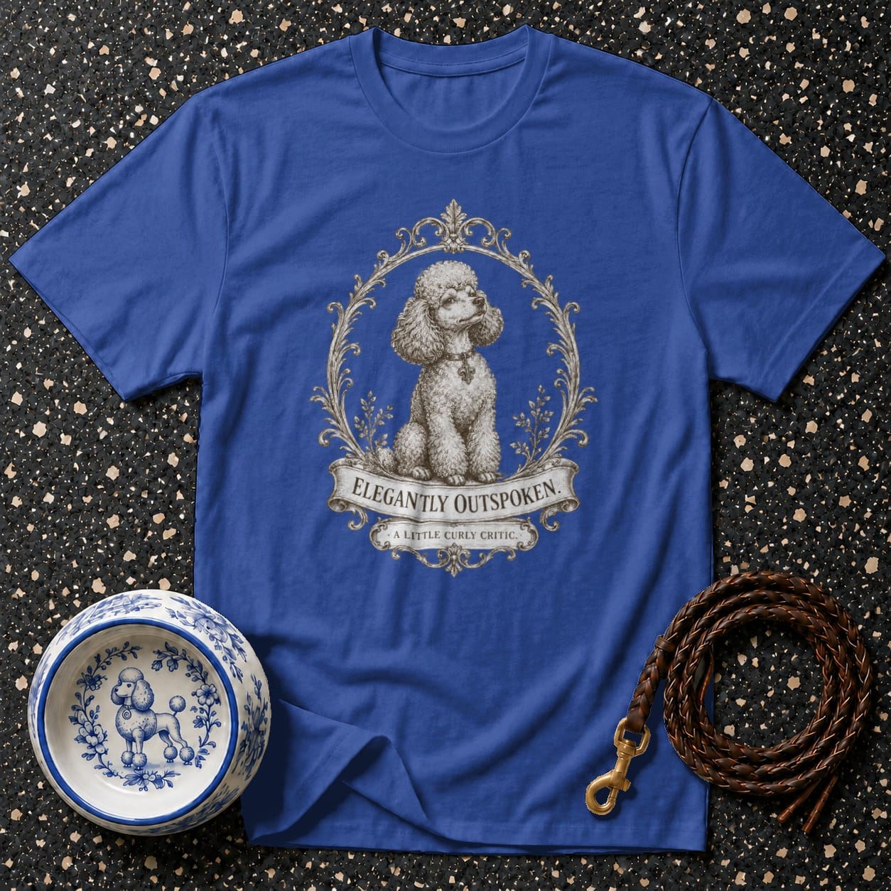 Blue t-shirt with a poodle illustration and "Elegantly Outspoken" text.