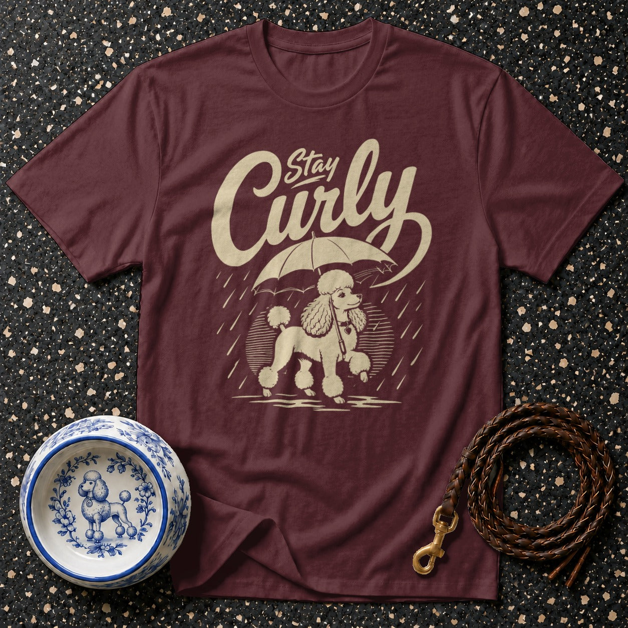 Maroon t-shirt with a poodle under an umbrella and the text "Stay Curly".