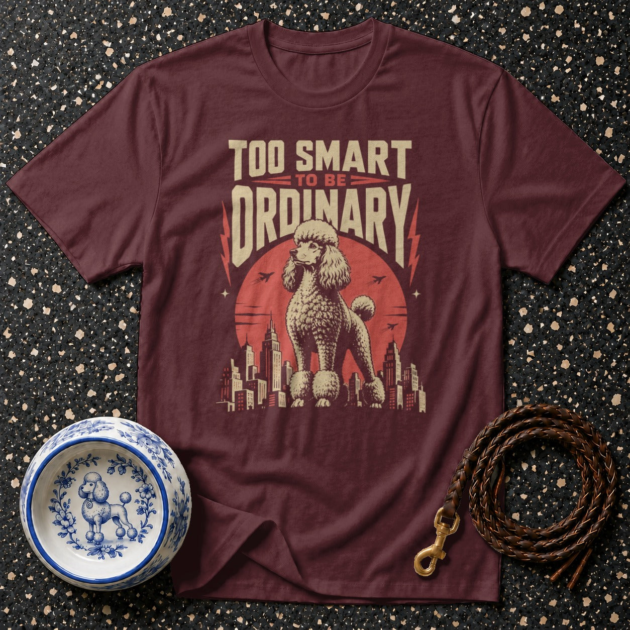 Maroon t-shirt with poodle and text "TOO SMART TO BE ORDINARY" graphic.