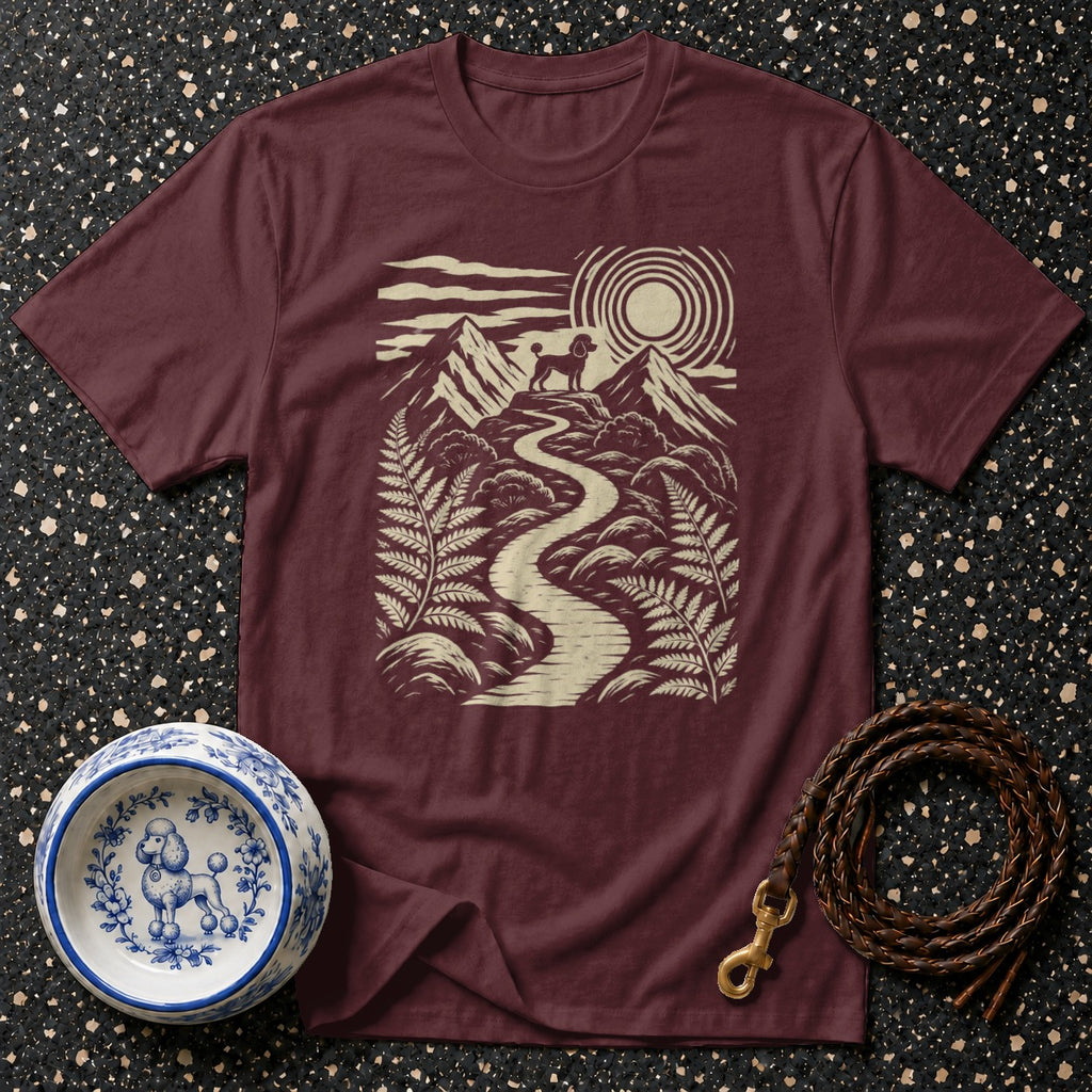 Maroon t-shirt with graphic of poodle on mountain path under sun.