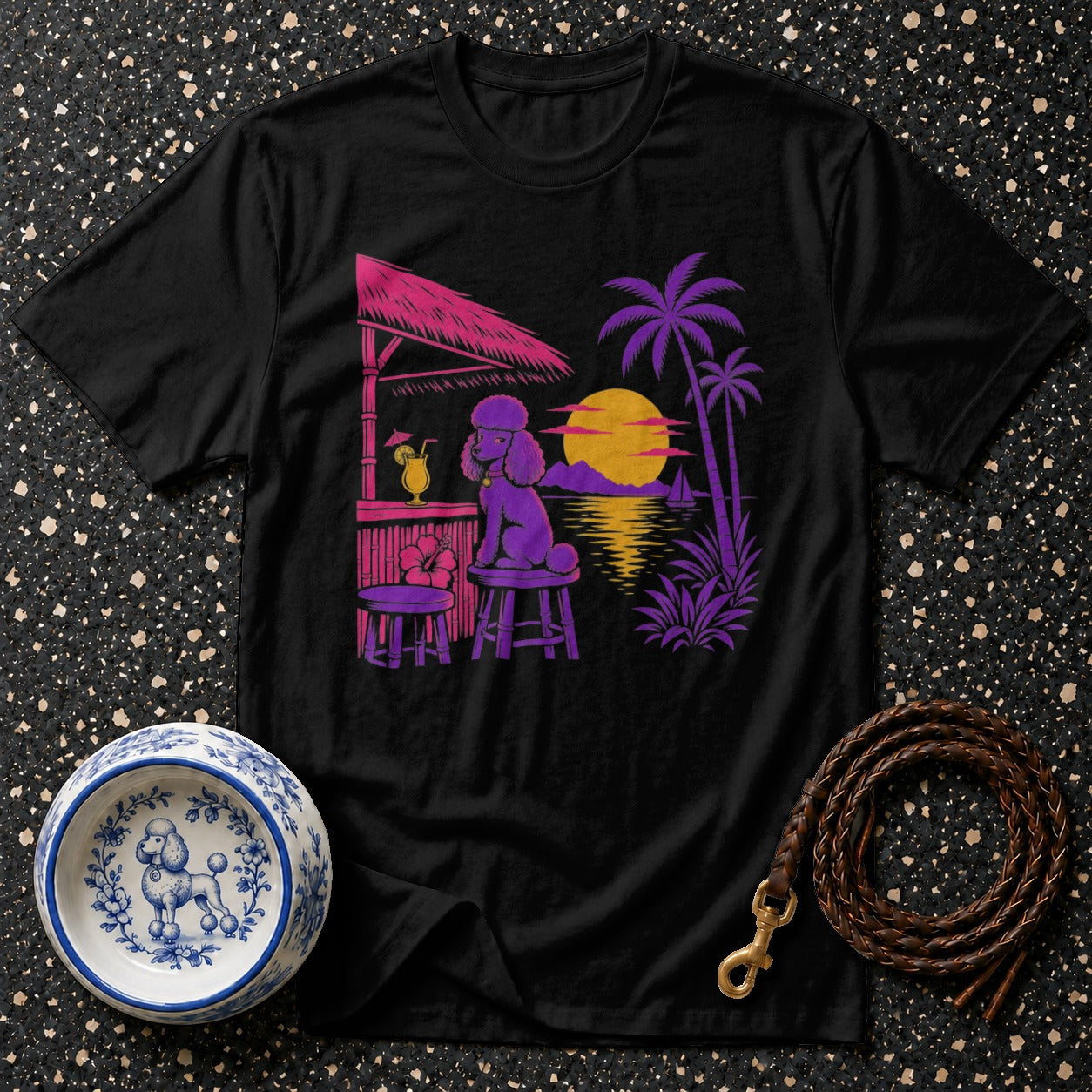 Black t-shirt with a purple poodle at a tiki bar on a tropical beach sunset.