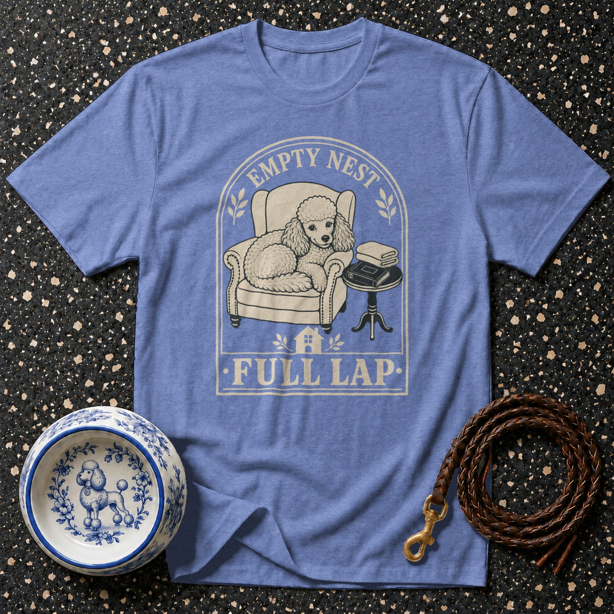 Blue t-shirt with graphic of poodle on chair text "Empty Nest Full Lap".