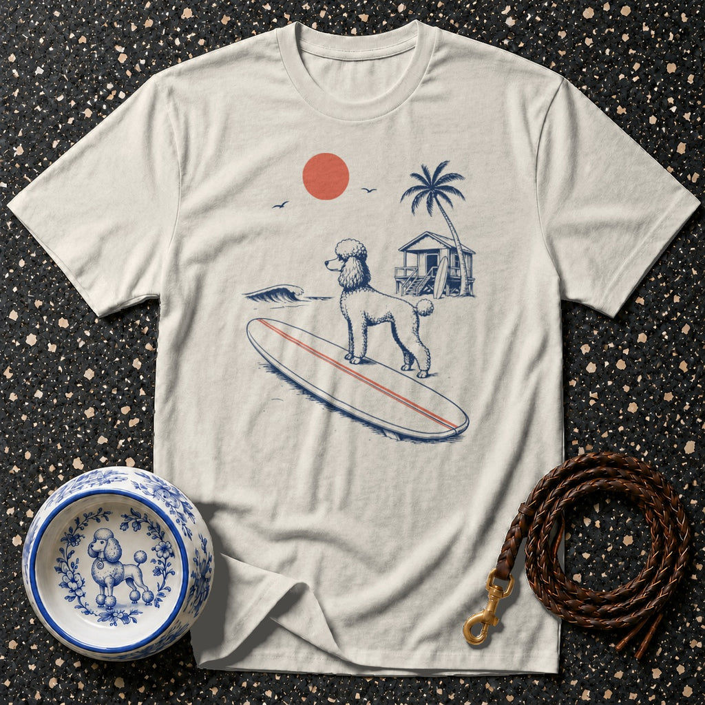 T-shirt with a doodle surfing on a surfboard at a beach with a cabin.