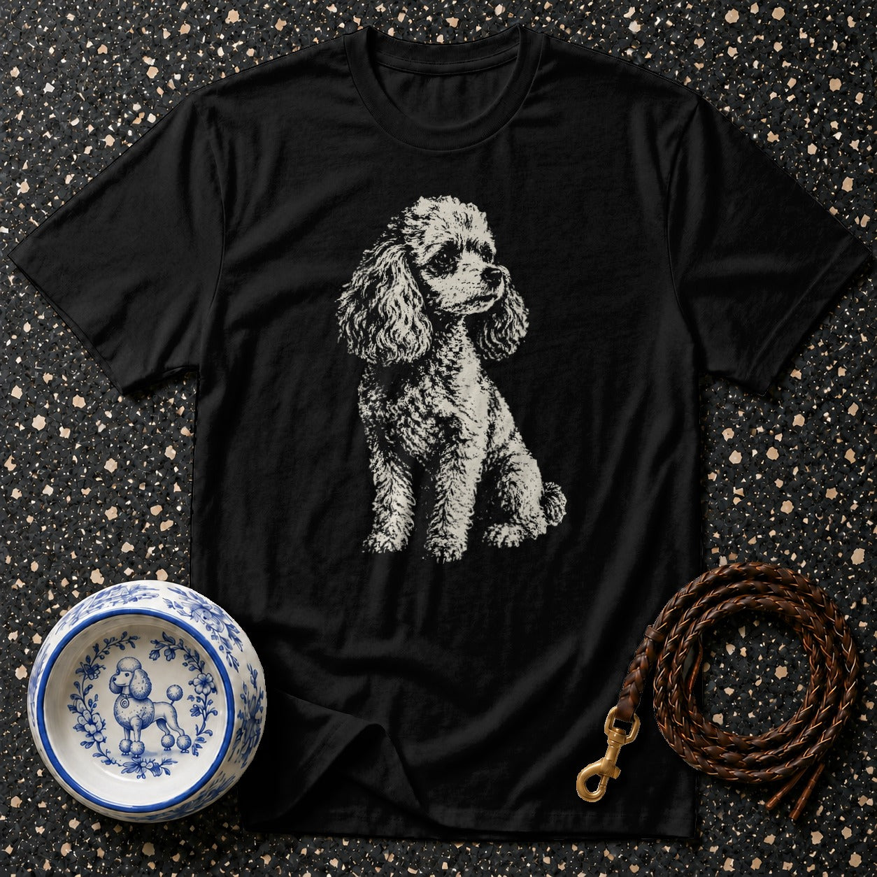 Black t-shirt with a poodle illustration, a poodle-themed dog bowl, and a braided leather leash.