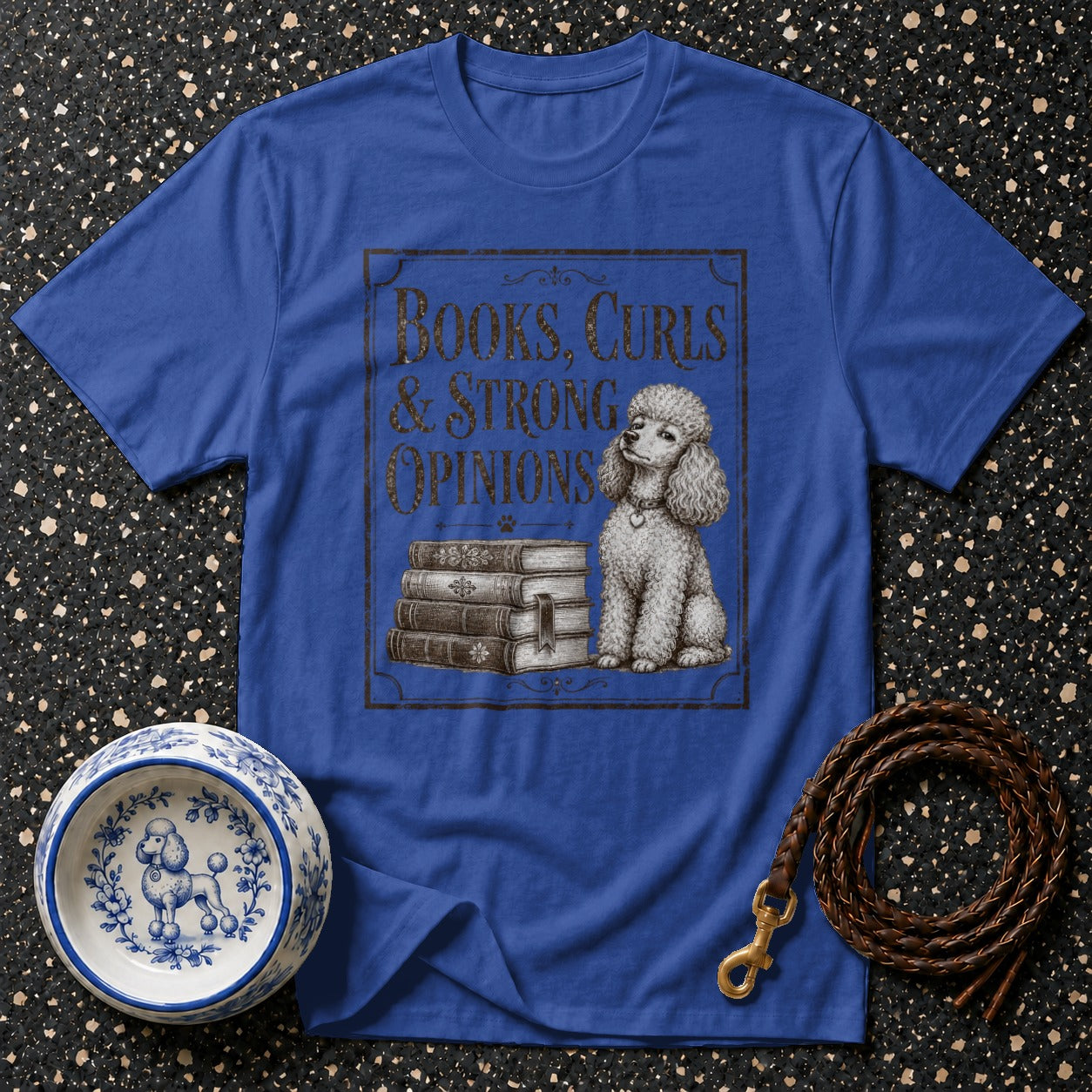 Blue t-shirt with "Books, Curls & Strong Opinions" text and a poodle graphic.