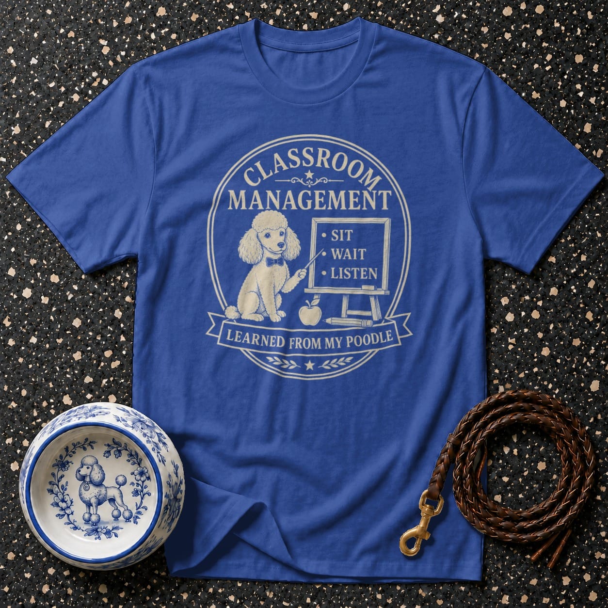 Blue t-shirt with a poodle graphic, text, and dog-themed accessories.