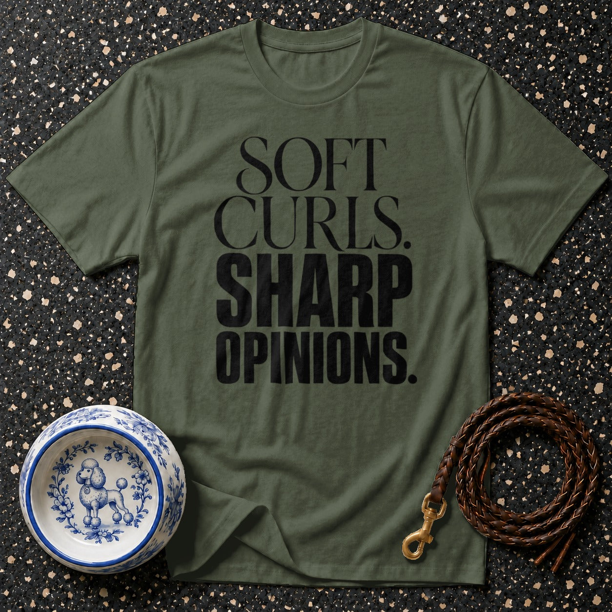 Olive green t-shirt with black text "SOFT CURLS. SHARP OPINIONS."