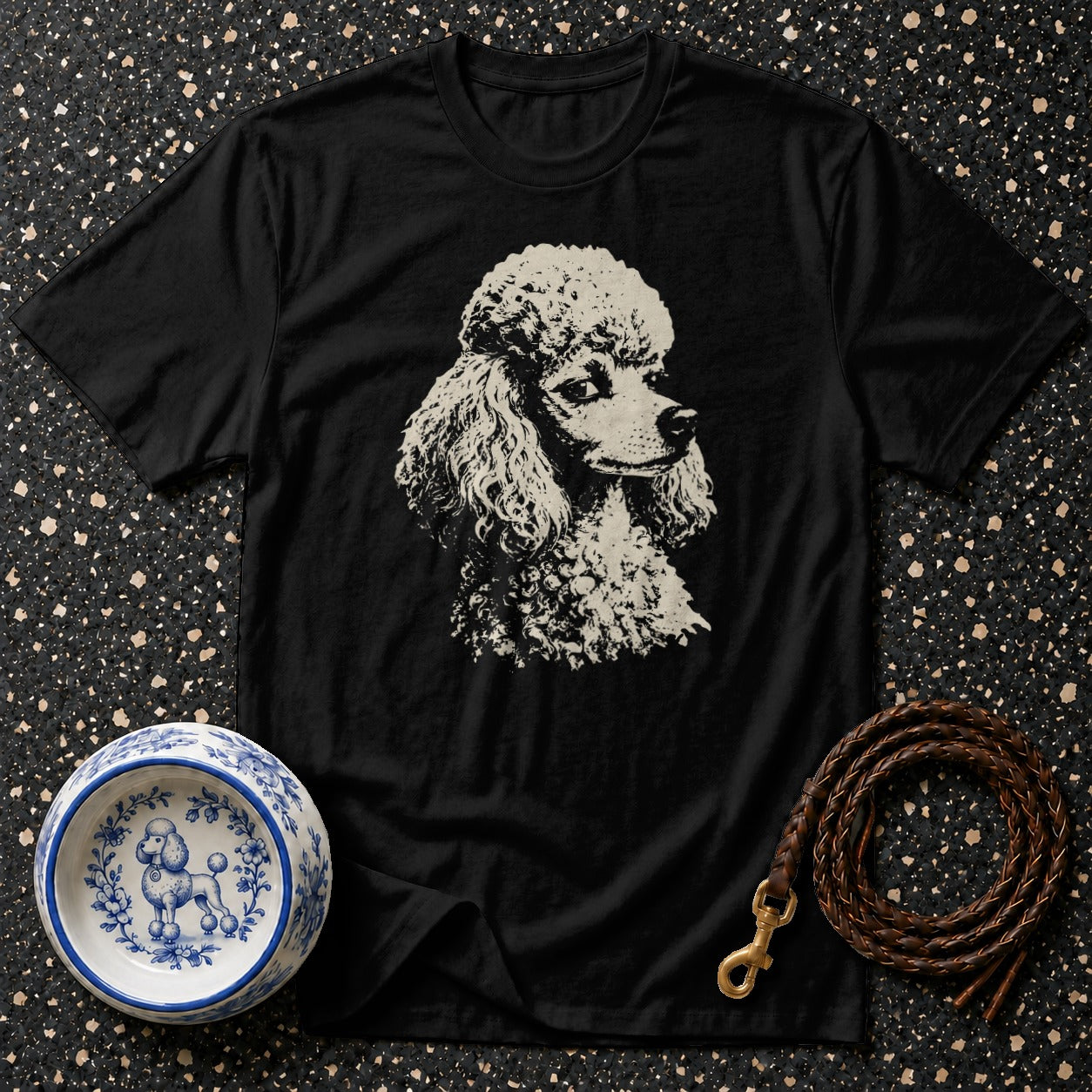 Black t-shirt with cream poodle graphic, blue poodle bowl, and leather leash.