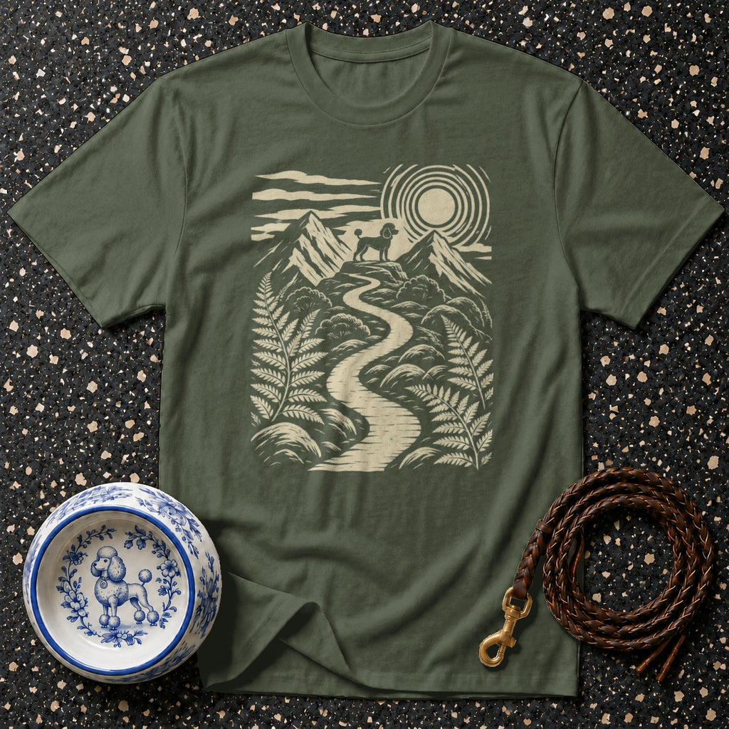 Green t-shirt with a stylized poodle on a mountain path at sunrise.