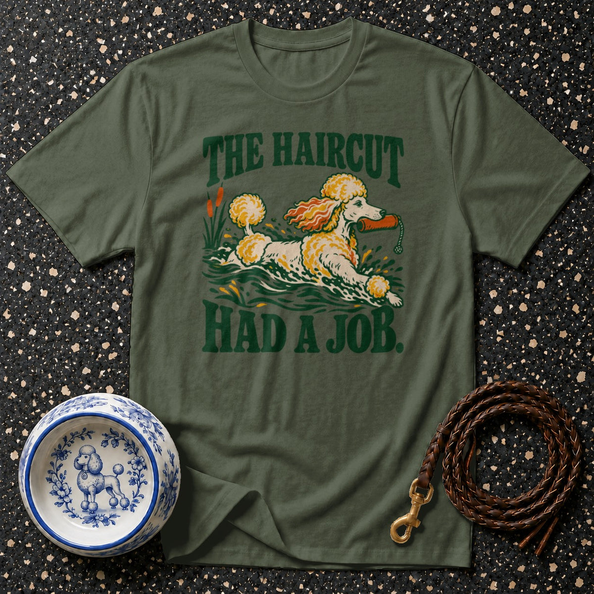 Olive green t-shirt with text and graphic of a poodle in water.
