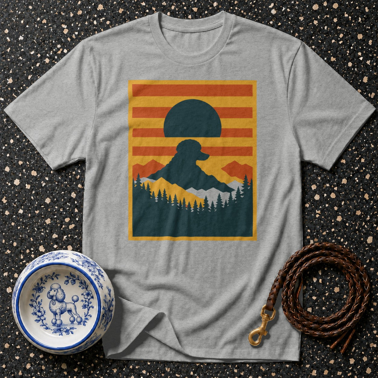Grey t-shirt with a silhouette of a dog and mountain landscape on the front.