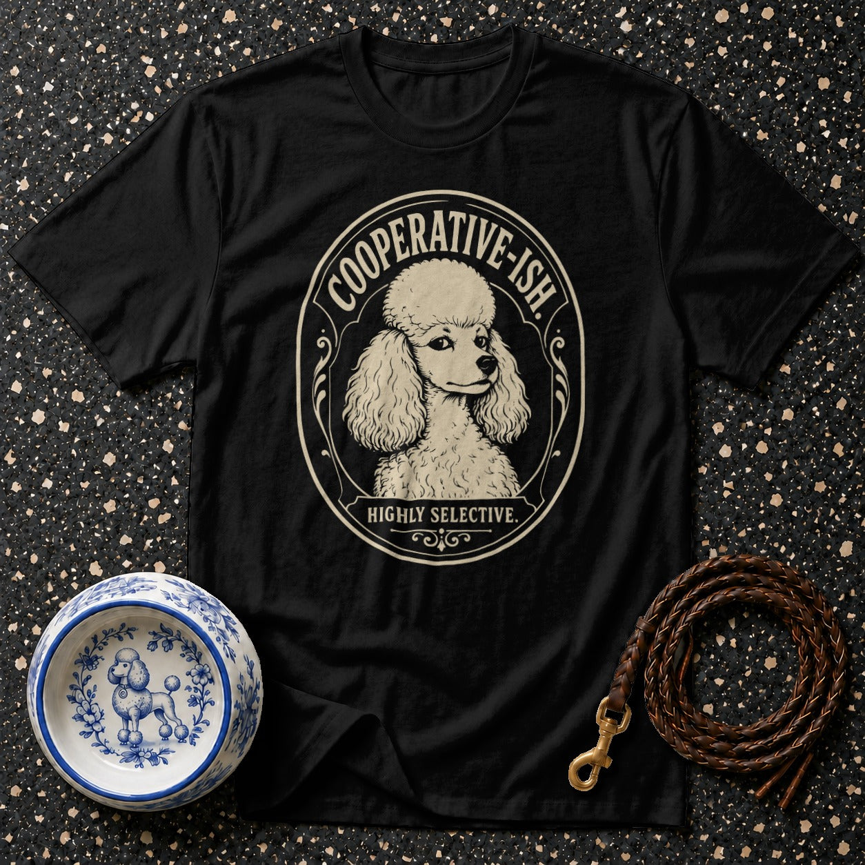 Black t-shirt with a poodle illustration and text "COOPERATIVE-ISH. HIGHLY SELECTIVE."