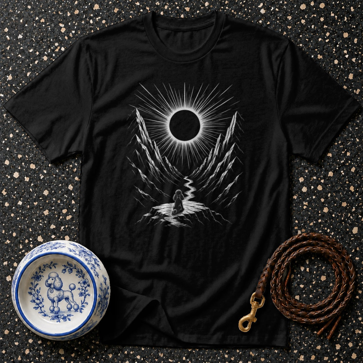 Black t-shirt with a stylized solar eclipse over a mountain valley.