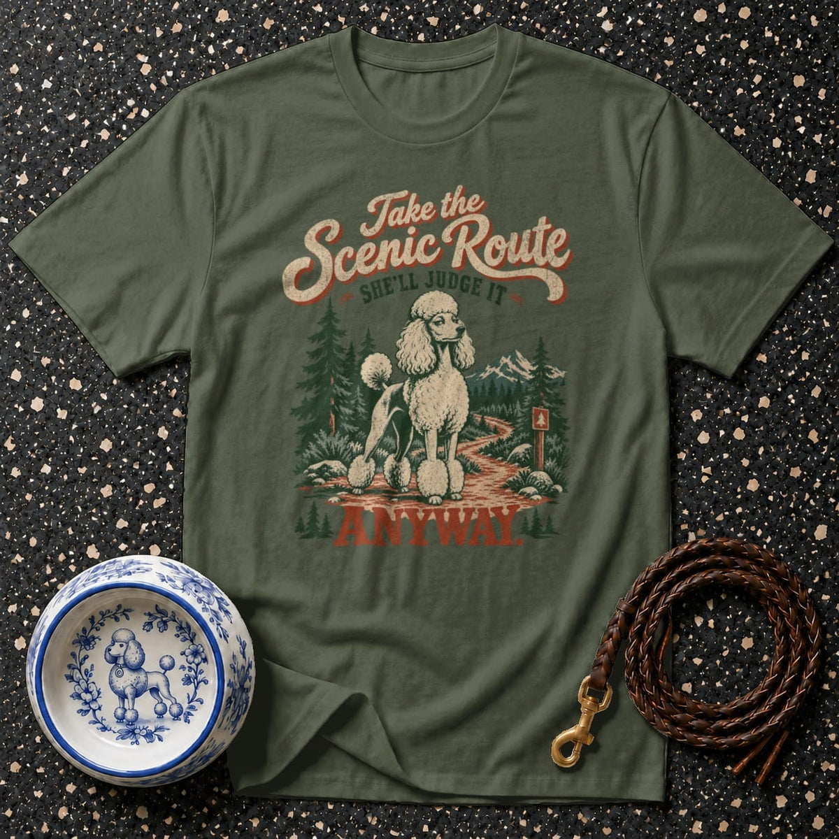 Green t-shirt with a poodle on a scenic route and text reading "Take the Scenic Route. She'll judge it anyway."