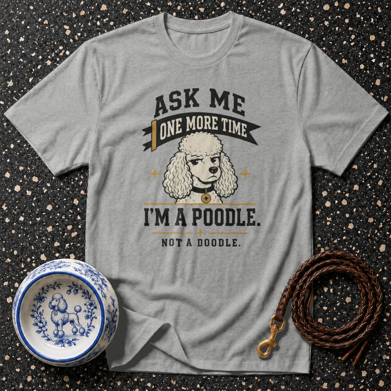 Gray t-shirt with a graphic of a poodle and text "Ask Me One More Time, I'm a Poodle. Not a Doodle."