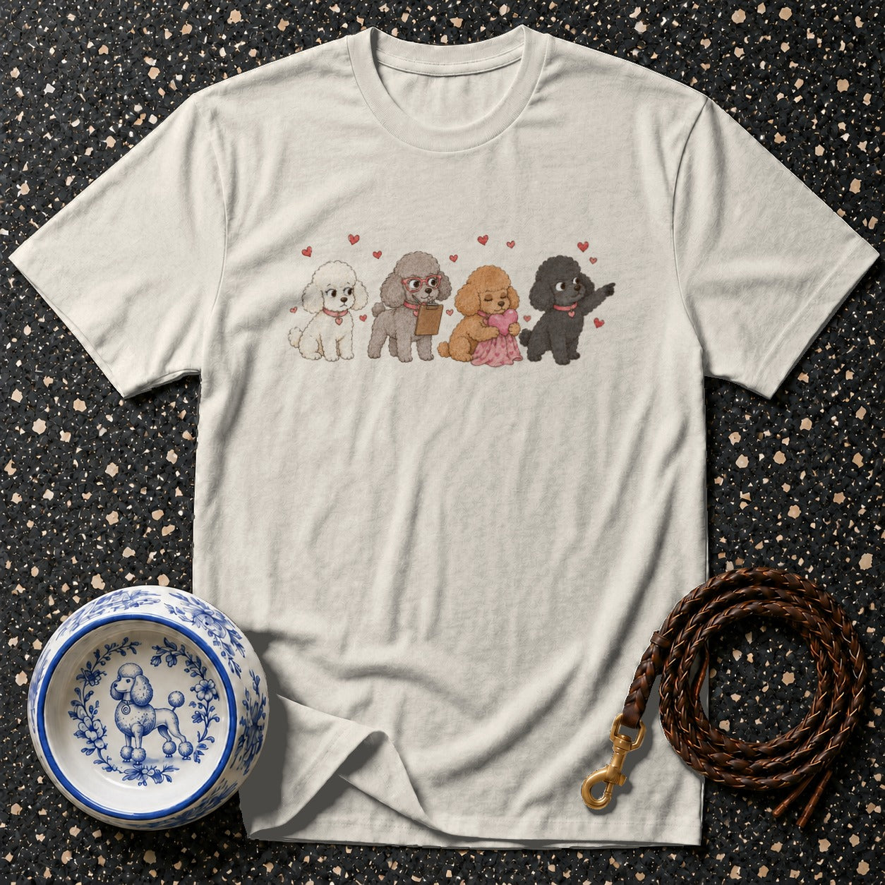 Cream t-shirt with four cartoon poodles in a row, some holding hearts.