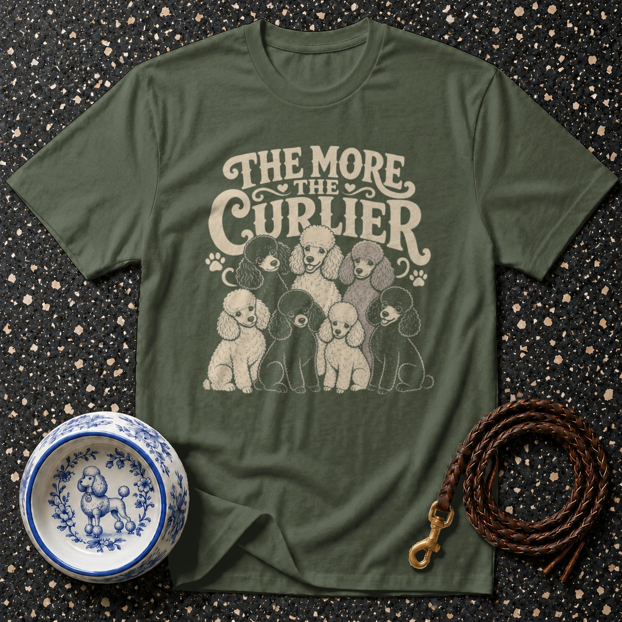 Olive green t-shirt with cream text "The More The Curlier" and a group of poodles.
