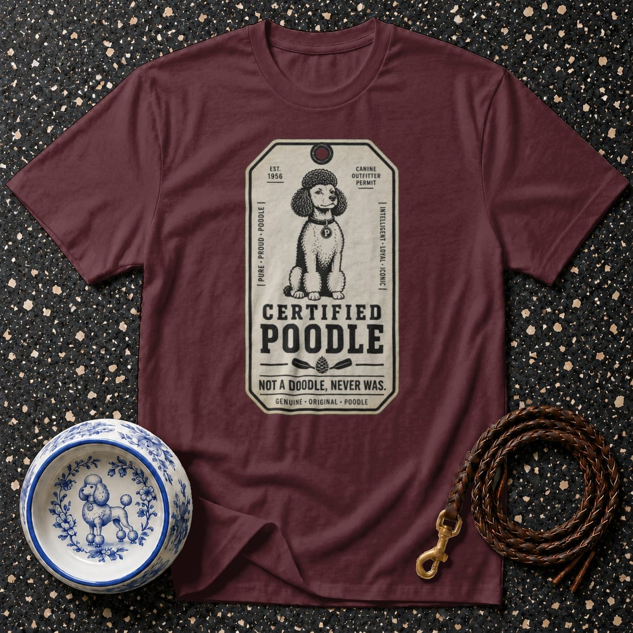 Maroon t-shirt with "Certified Poodle" and poodle illustration tag design.