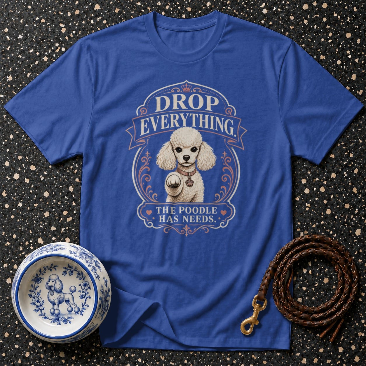 Blue t-shirt with "DROP EVERYTHING THE POODLE HAS NEEDS" and a poodle graphic.