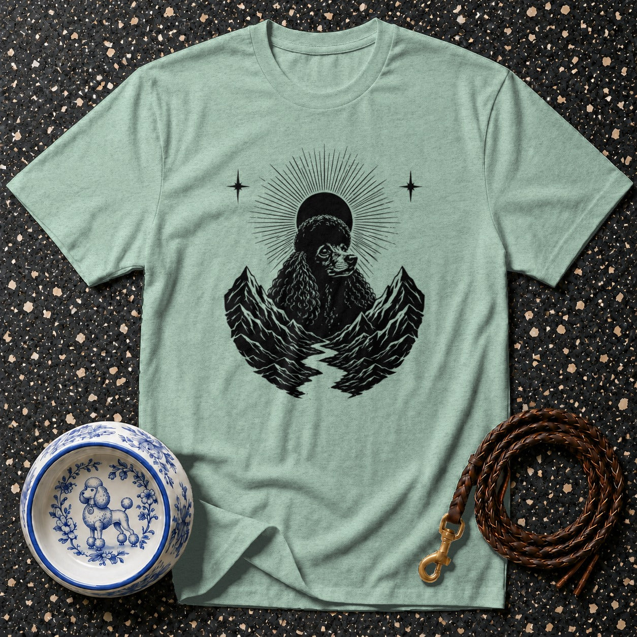 Light mint t-shirt with black poodle, mountains, sun, and stars graphic.