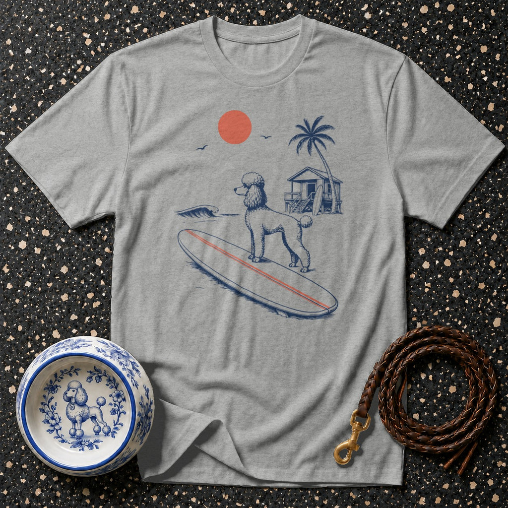 Grey t-shirt with a poodle surfing on a surfboard on a beach scene.