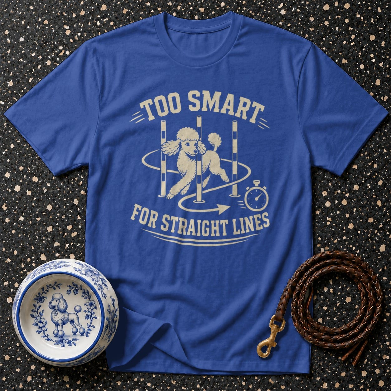 Blue t-shirt with cream graphic of poodle doing agility course and text "TOO SMART FOR STRAIGHT LINES".