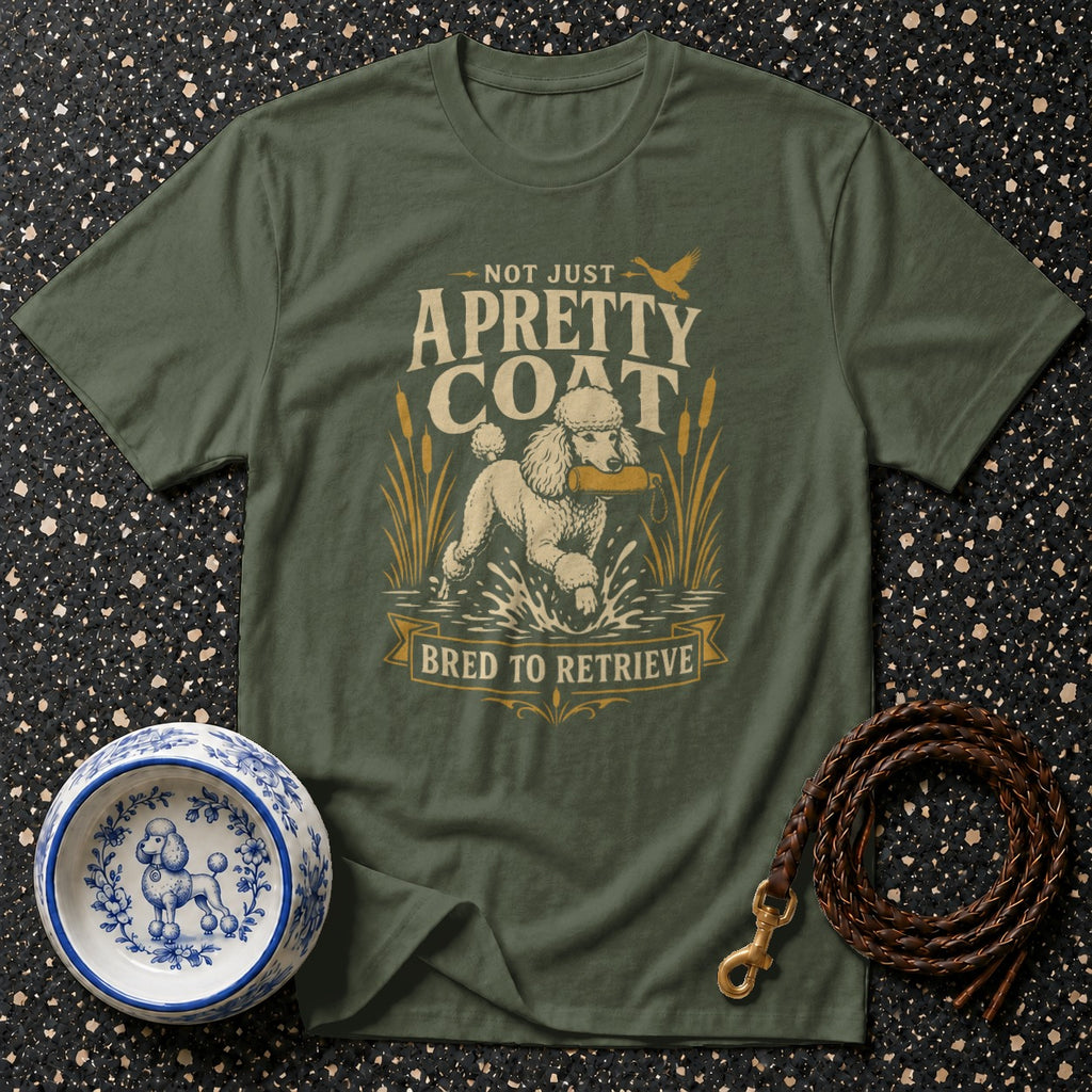 Olive t-shirt with poodle retrieving a dummy. Text: "Not just a pretty coat, bred to retrieve."