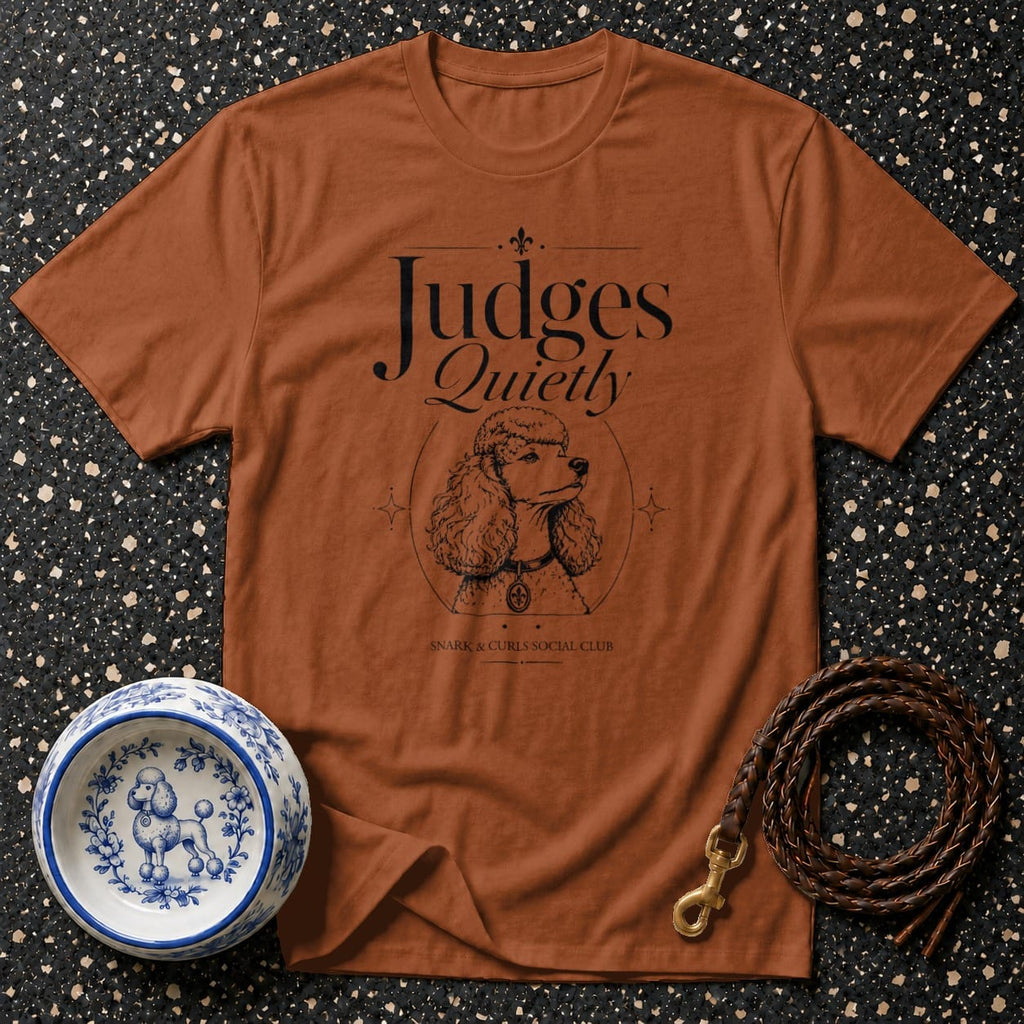 Brown t-shirt with "Judges Quietly" text and poodle illustration.