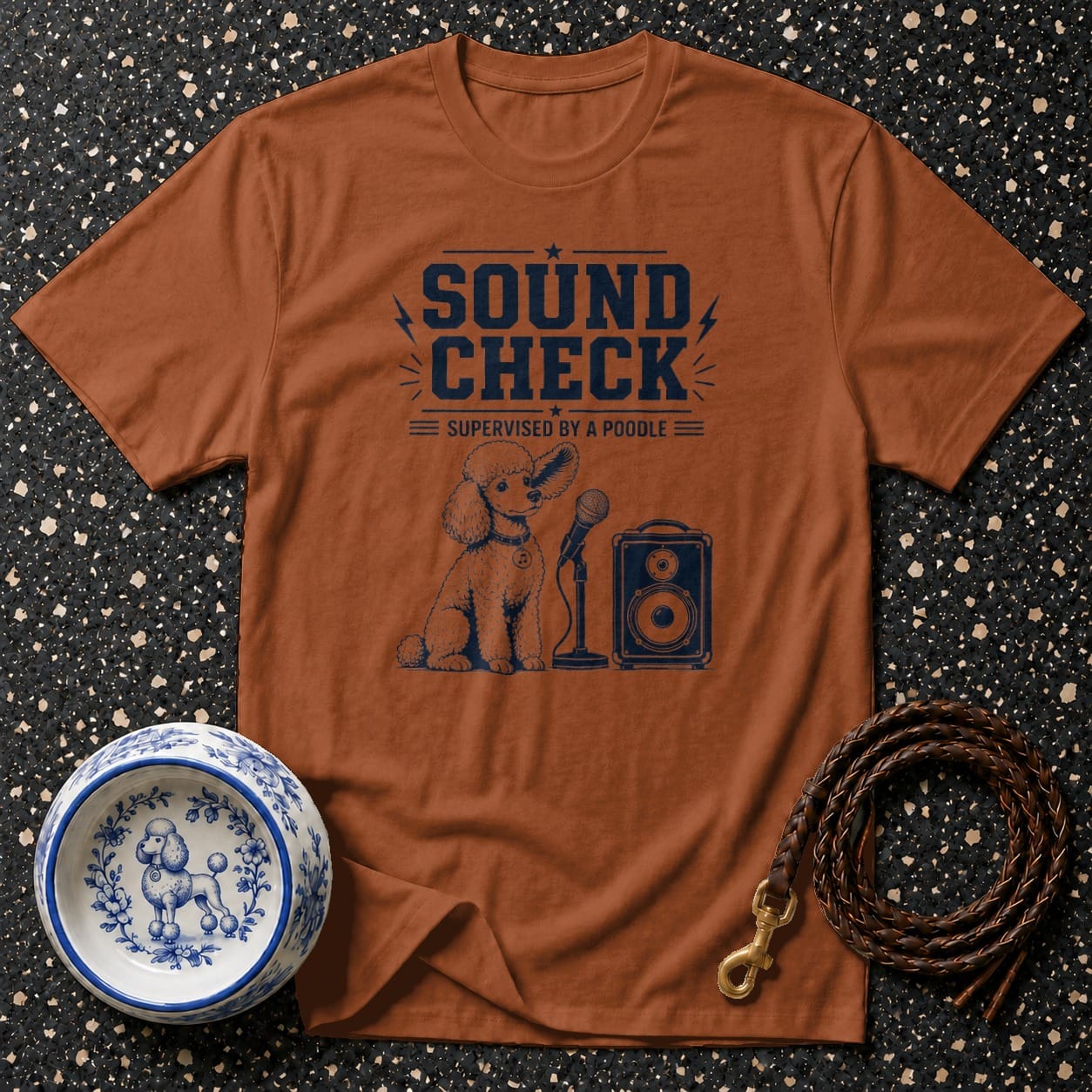 Brown t-shirt with "Sound Check Supervised by a Poodle" text and poodle graphic.
