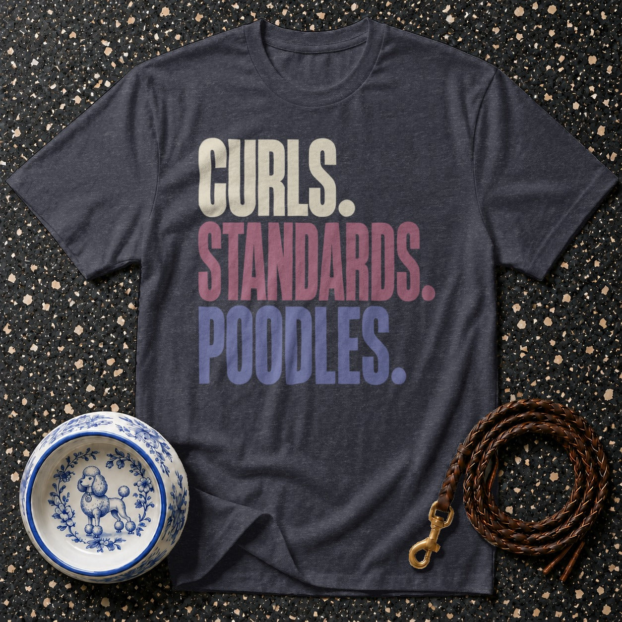 Dark grey t-shirt with text "Curls. Standards. Poodles." on a speckled background.