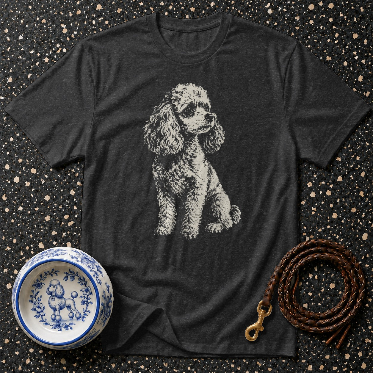 Dark grey t-shirt with distressed poodle graphic, blue and white poodle bowl, and braided leather leash.