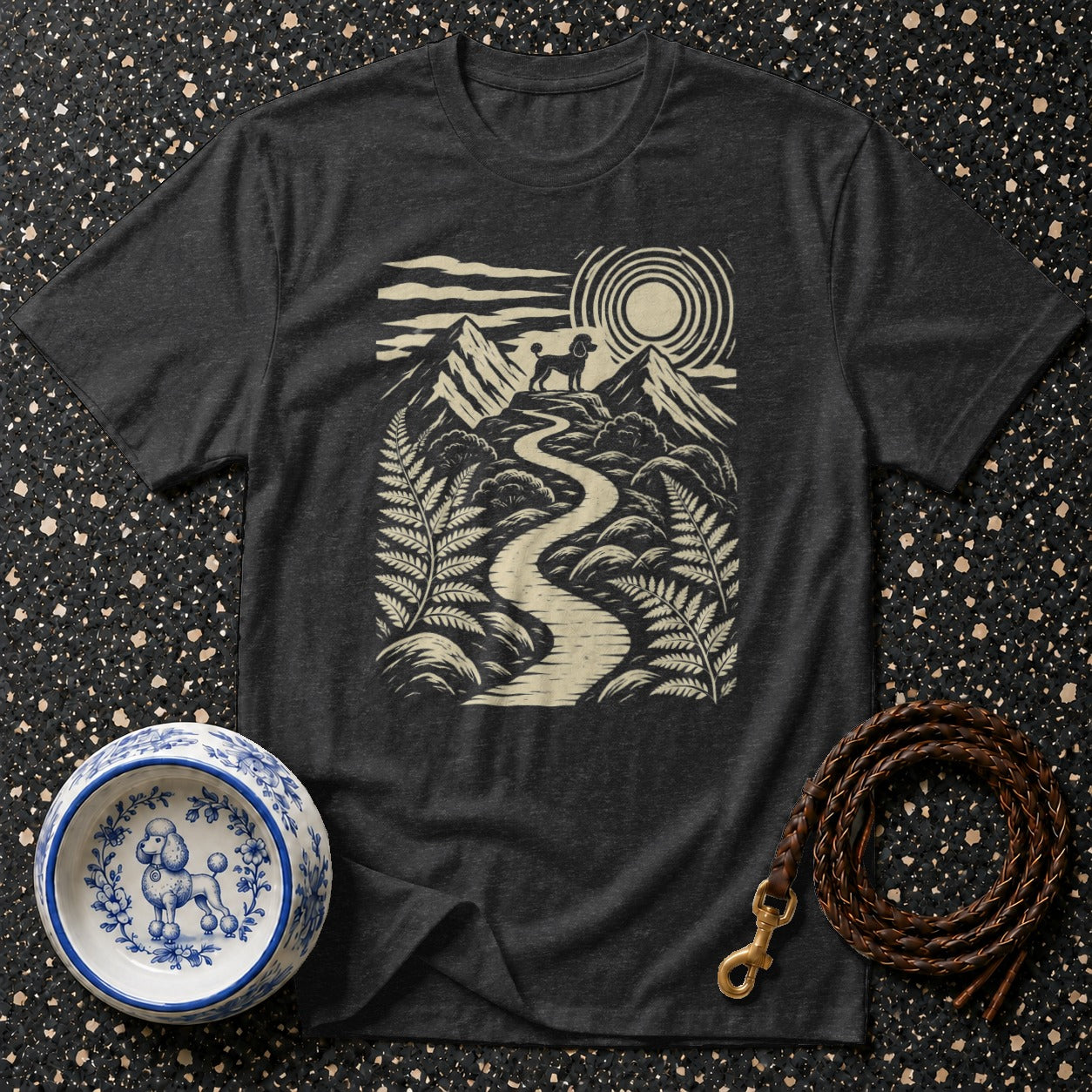 Dark grey t-shirt with a graphic of a poodle on a mountain path.