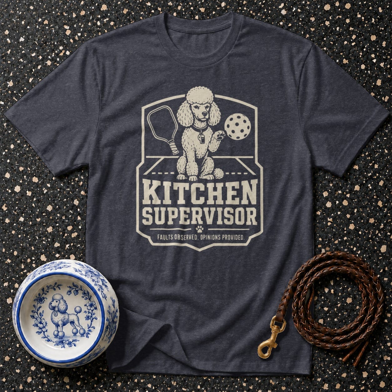 Dark t-shirt features a distressed graphic of a poodle with pickleball gear and text reading "Kitchen Supervisor".