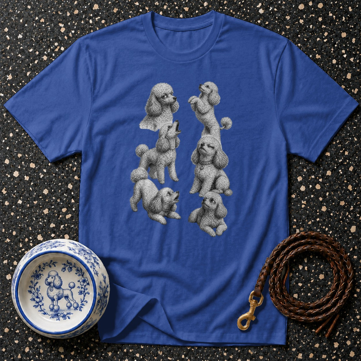 Blue t-shirt with playful gray poodles illustration, bowl, and leash.
