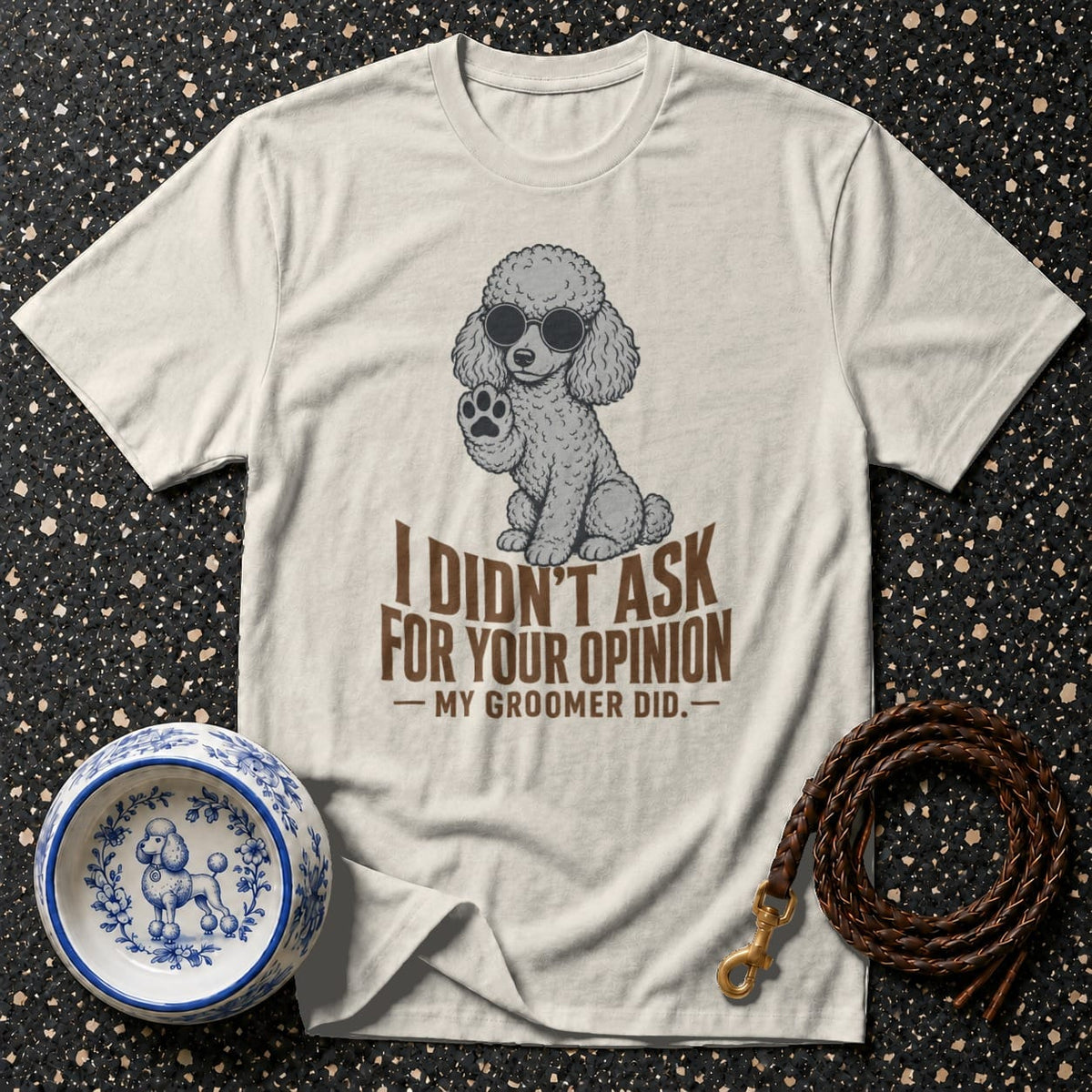 Cream t-shirt with graphic of poodle wearing sunglasses and text "I didn't ask for your opinion - My groomer did."