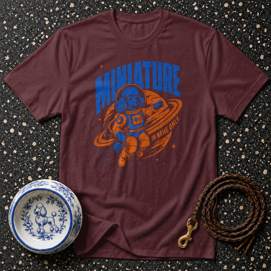 T-shirt with a blue poodle in an orange astronaut suit floating in space.