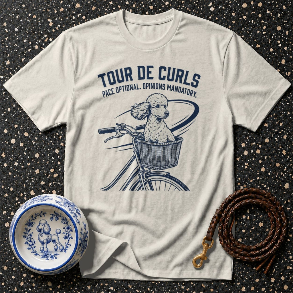 Cream t-shirt with graphic of poodle in bicycle basket and text "Tour De Curls".