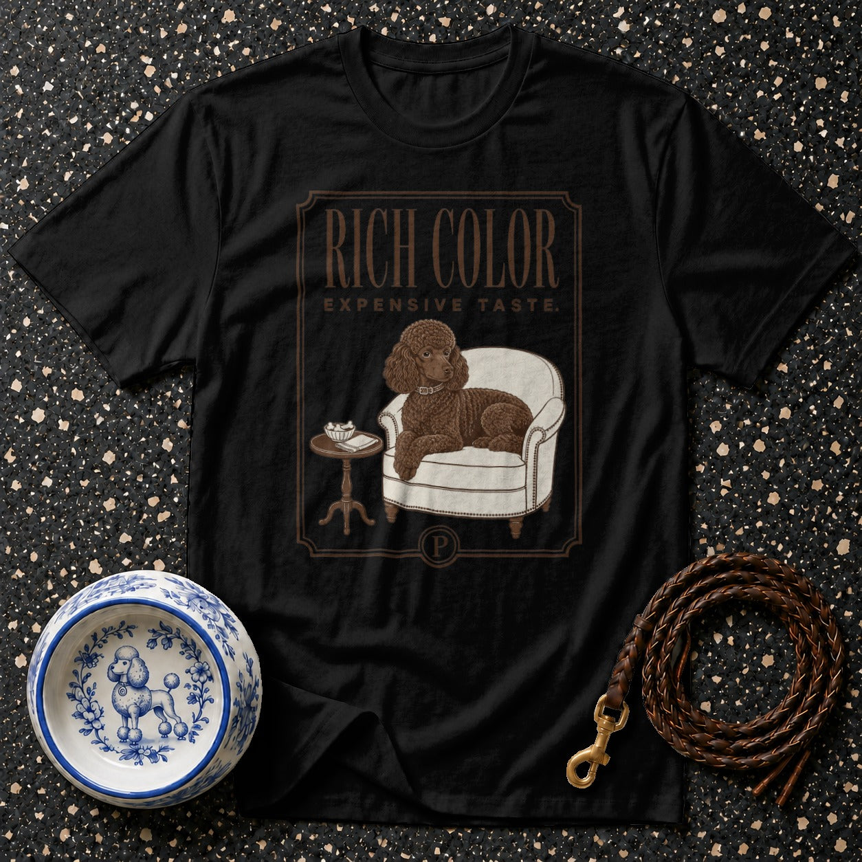 Black t-shirt with a brown poodle sitting in a chair, text reads "RICH COLOR EXPENSIVE TASTE."