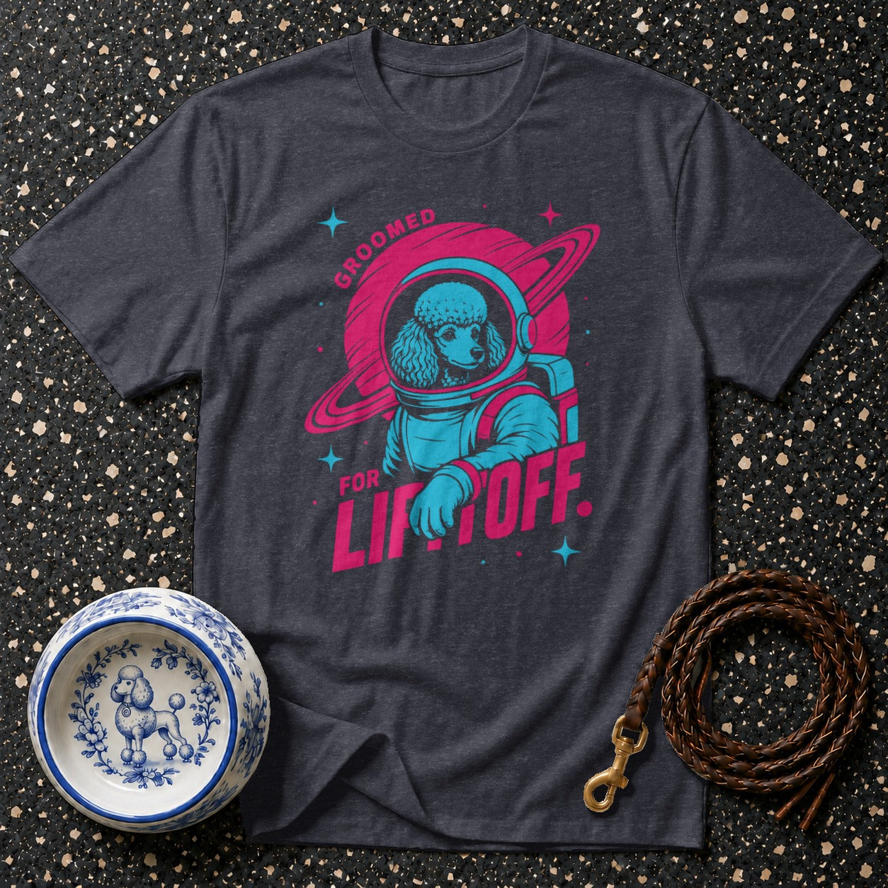 Dark grey t-shirt with poodle in astronaut suit and text "GROOMED FOR LIFTOFF".