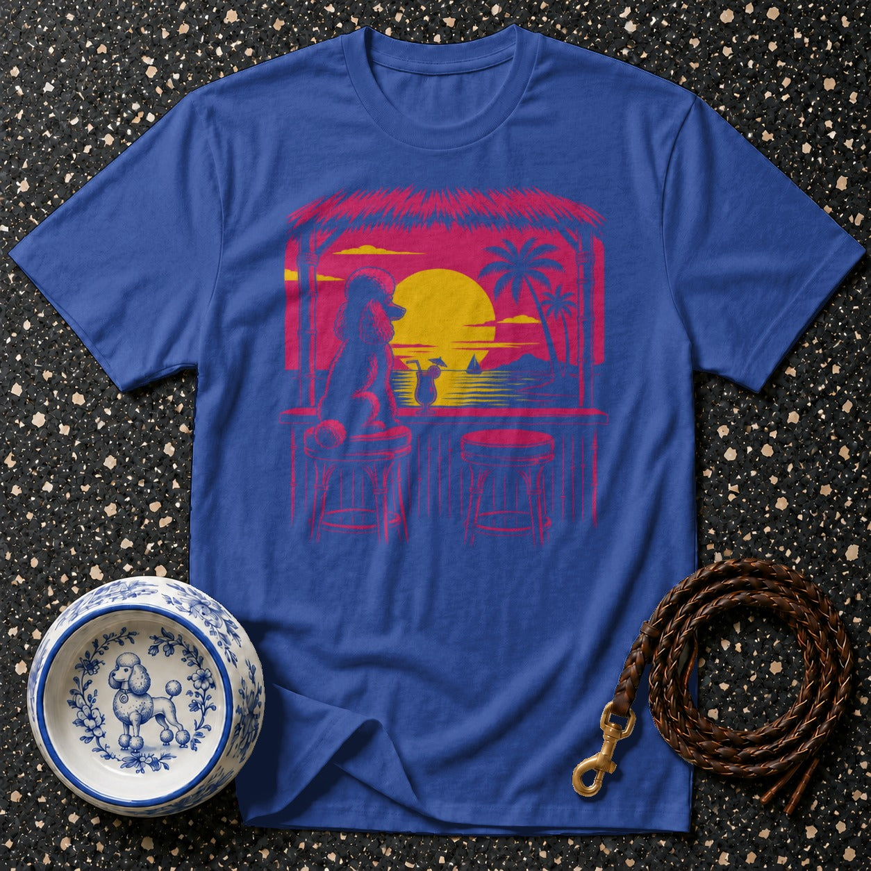 Blue t-shirt featuring a poodle at a tropical bar during sunset.