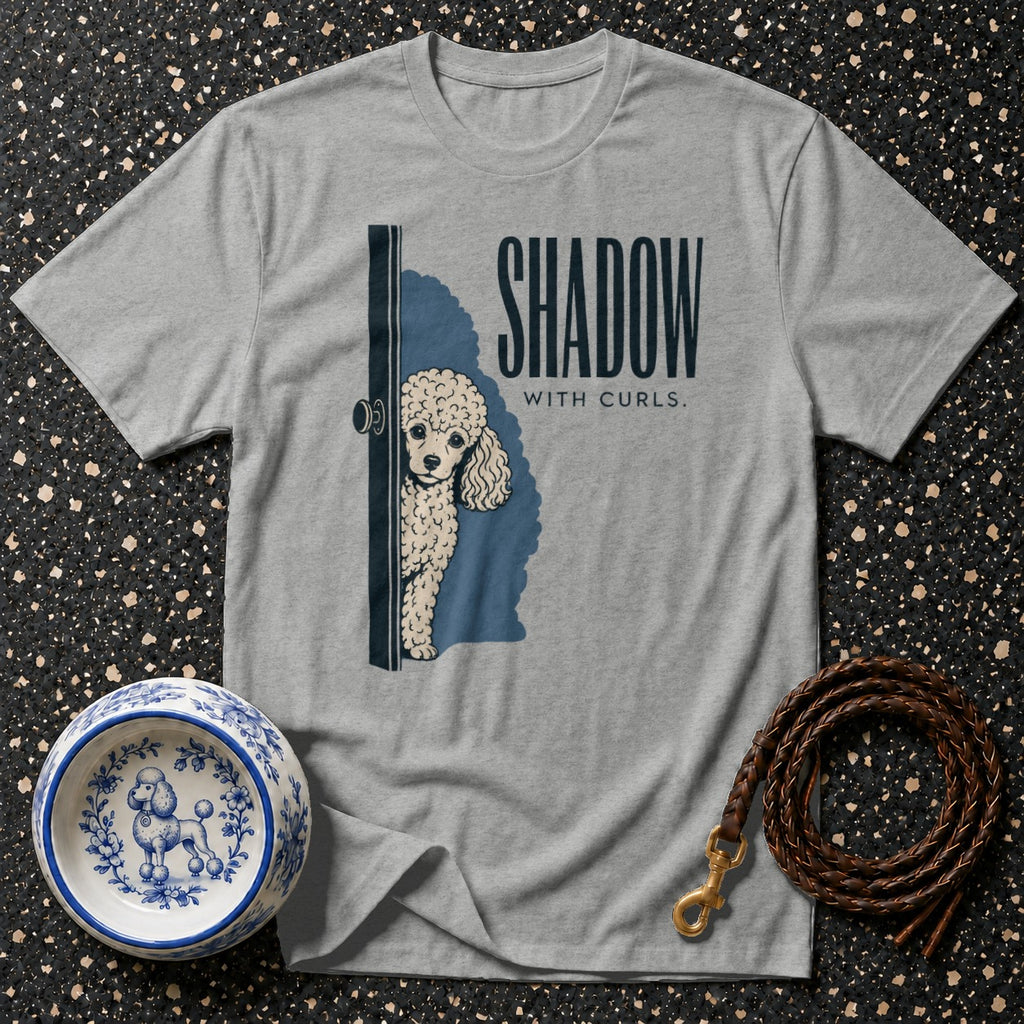 Grey t-shirt with poodle peeking from behind a door, "Shadow with Curls." text.