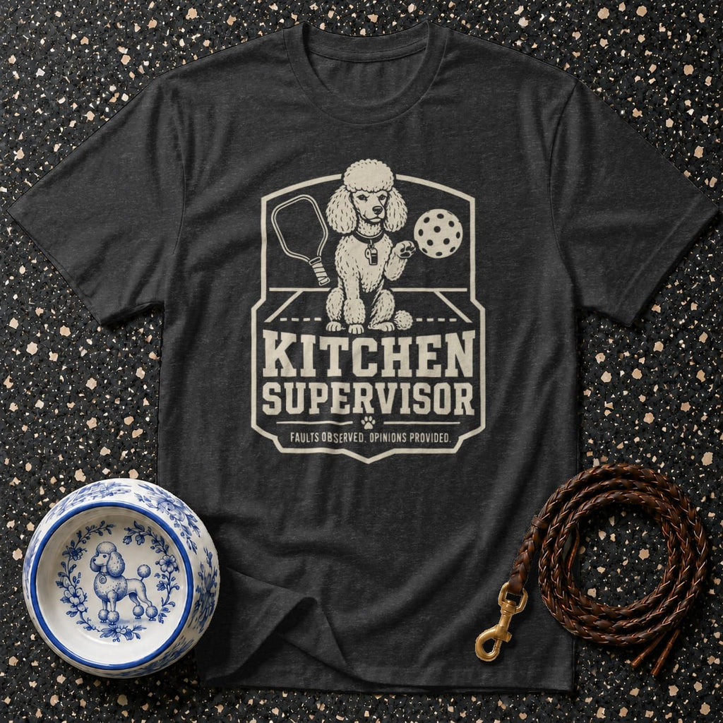 Dark t-shirt with graphic of a poodle holding a pickleball paddle and ball. Text reads "KITCHEN SUPERVISOR".