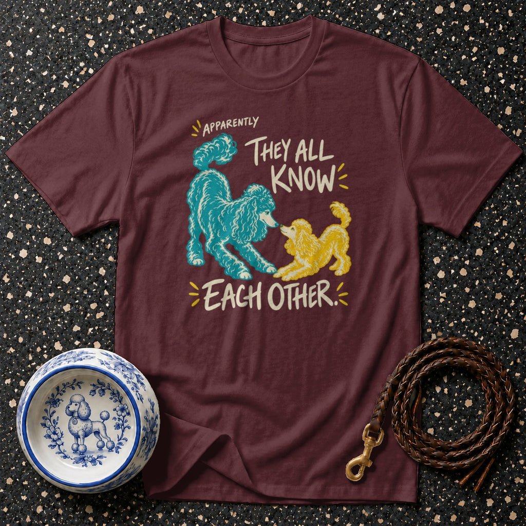 Maroon t-shirt with blue and yellow poodles and text "APPARENTLY THEY ALL KNOW EACH OTHER."