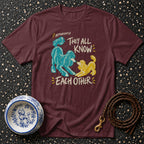 Maroon t-shirt with blue and yellow poodles and text "APPARENTLY THEY ALL KNOW EACH OTHER."
