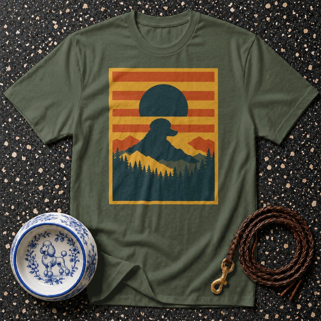 Green t-shirt with a mountain sunset scene featuring a dog silhouette.