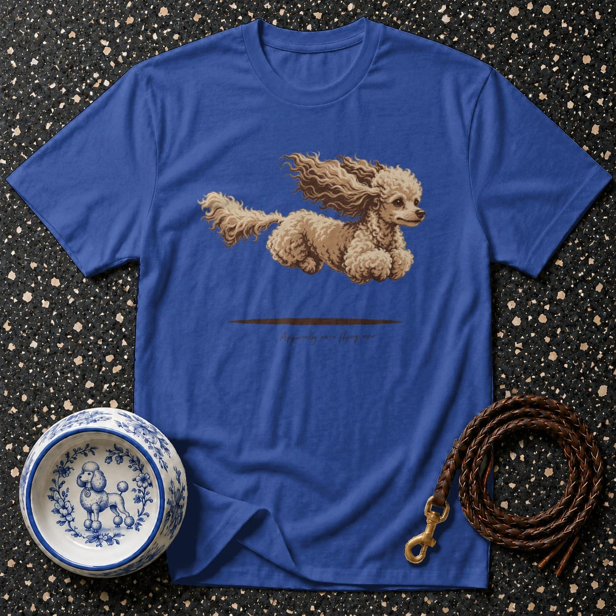 Blue t-shirt with a poodle graphic and text "Apparently we are flying now."