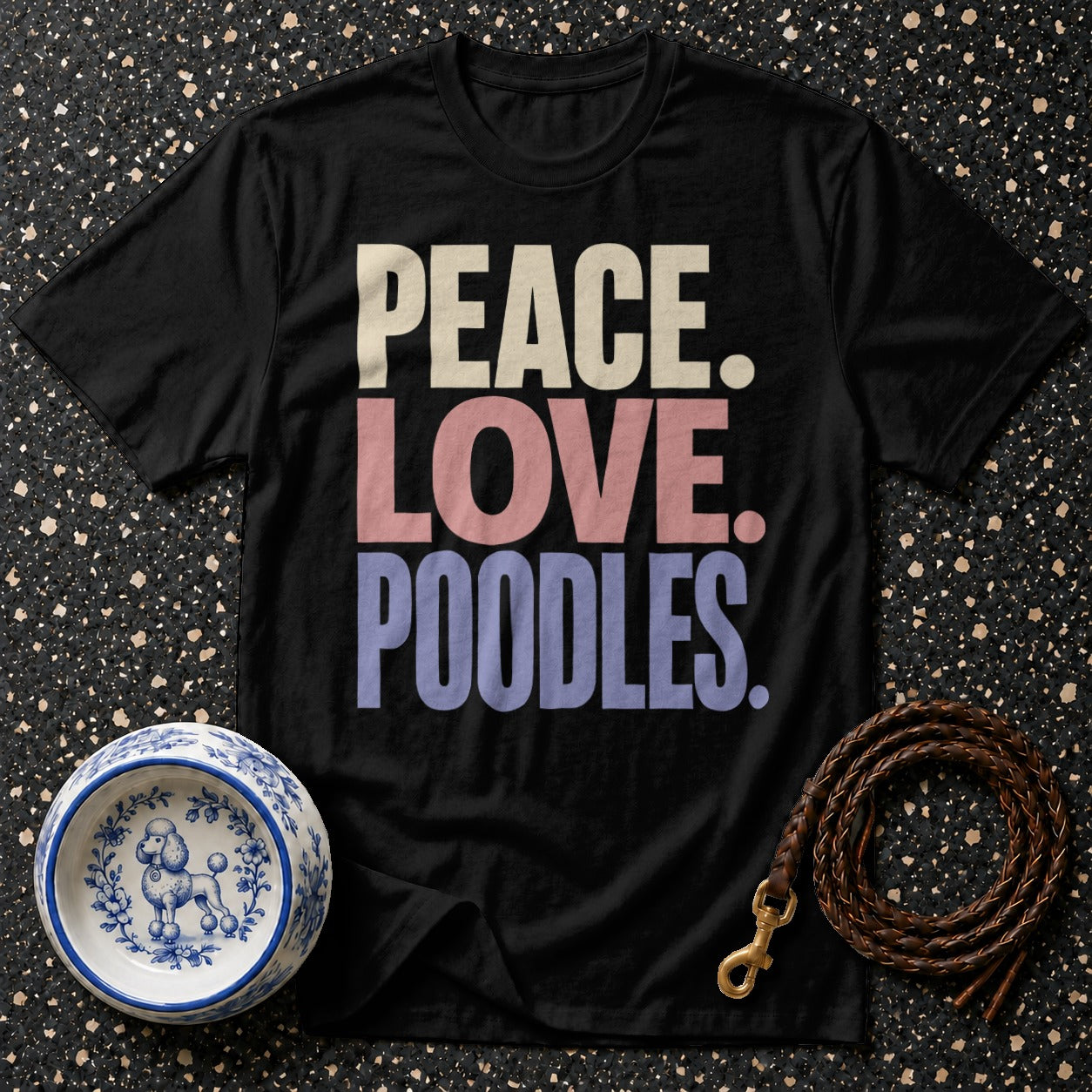 Black t-shirt with text "PEACE. LOVE. POODLES.", a dog bowl, and a leash.