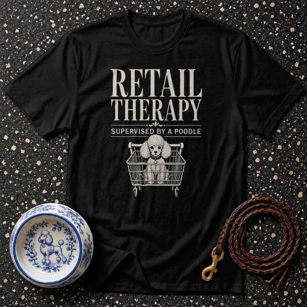 Black t-shirt with "Retail Therapy Supervised by a Poodle" text and poodle in shopping cart graphic.