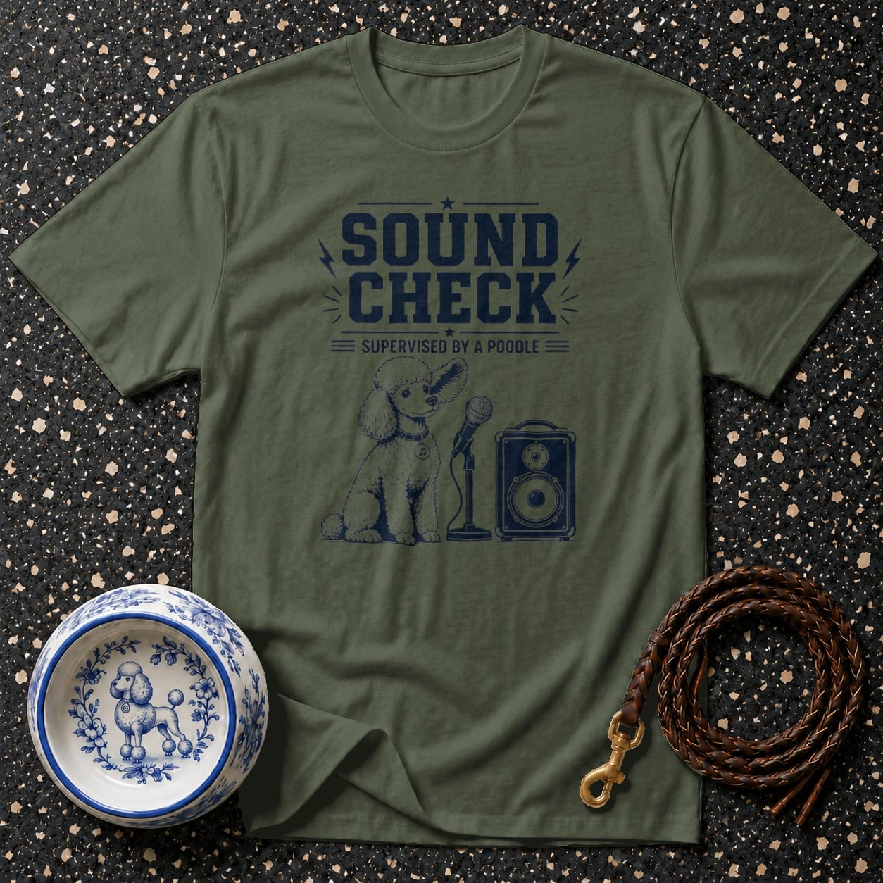 Green t-shirt with navy graphic of a poodle, microphone, and speaker, reading "Sound Check Supervised by a Poodle".